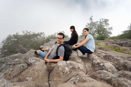 Family travels on a nature trip in a misty tropical forest.の写真素材