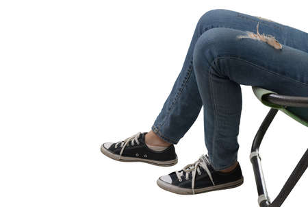 Legs wearing sneakers and jeans.の写真素材