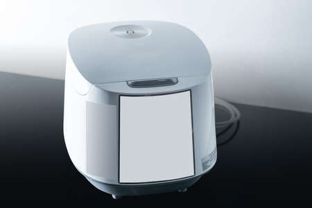 white rice cooker on black backgroundの写真素材