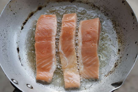 Salmon fried in oil in a panの写真素材