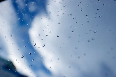 water droplets on glass sky backgroundの写真素材