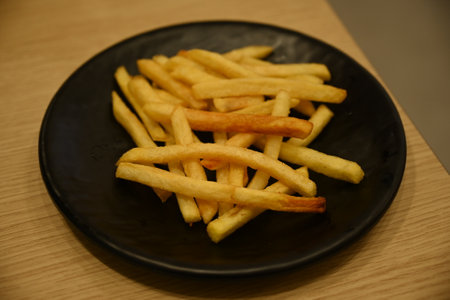 french fries in a black plateの写真素材