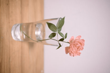 Rose in glass vase on wooden background,vintage color toneの写真素材