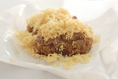 Crispy fried chicken with grated coconut on white background.の写真素材