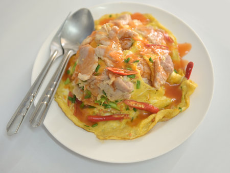 Omelet with pork and chilli on white dish, Thai foodの写真素材