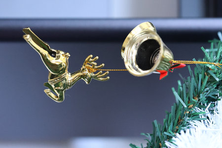 christmas bell and angel on the tree, closeup of photoの写真素材