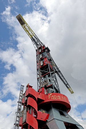 Crane at the NDSM Wharf in Amsterdam Noord, Netherlands, with blue and cloudy skyのeditorial素材