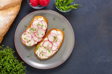 Healthy  delicious sandwiches with soft cream cheese and radish. Vegetarian food. Top view.の写真素材