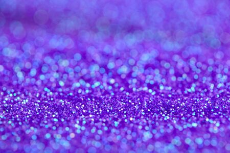 Ultra violet background with shiny bokeh. Holiday abstract glitter background with blinking lights.の写真素材
