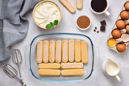 Product for preparing tiramisu dessert. Top view of ingredients on a light background.