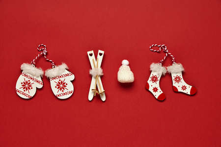 Christmas banner. Toy attributes of winter and Christmas on a red background. Concept of symbolic...