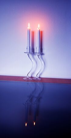 Two white candles on a white backgroundの写真素材