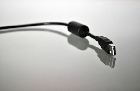 black usb cable on a reflecting undergroundの写真素材