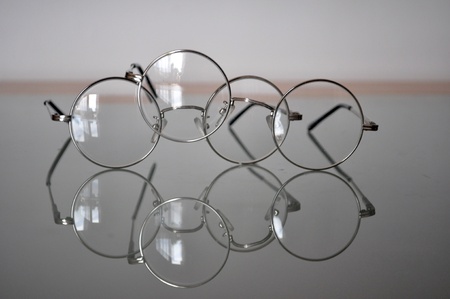 round glasses reflected on the glass surface