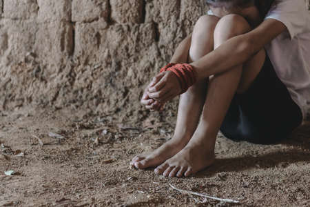 Kidnapped little girl tied with rope.Abused and tortured concept. Human trafficking concept. Stop violence against Women. International women's Day. Stop abusing violence.の写真素材