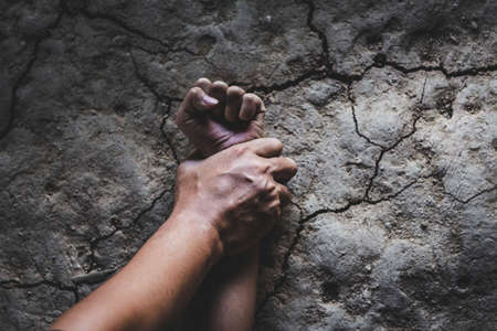 Hands for rape and sexual abuse concept.Sexual abuse is a problem or Social issues concept. Man's hand holding a woman hand for rape and sexual abuse.の写真素材