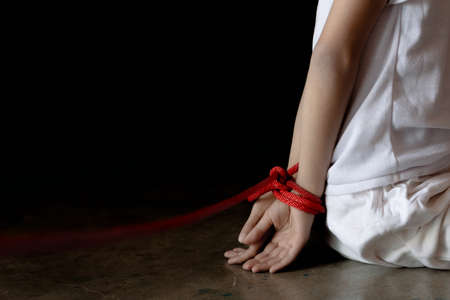 little boy tied with chained. Abused and tortured concept. Human trafficking concept.の写真素材