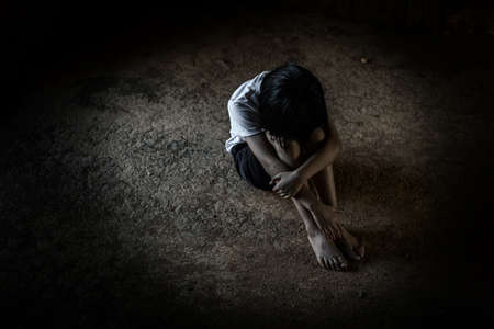 hand holding Cannabis oil in bottle of against Marijuana plant, Growing medical marijuana.の写真素材