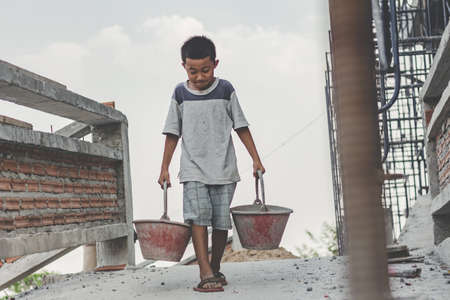 Children working at construction site for world day against child labour concept:の写真素材