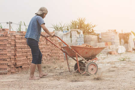 Child working in a brick factory. world day against child labour conceptの写真素材