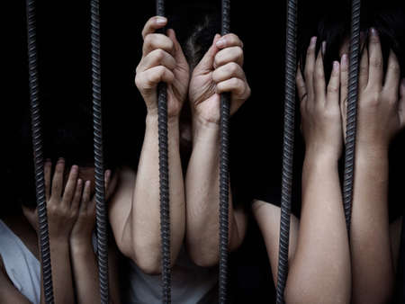 women and children in catch the iron prison, Human trafficking concept, human rights violations,の写真素材