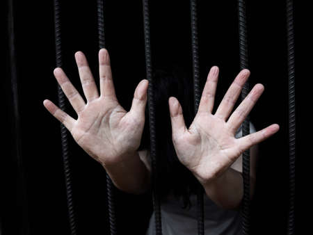 Stop human trafficking concept, human rights violations, women in catch the iron prison