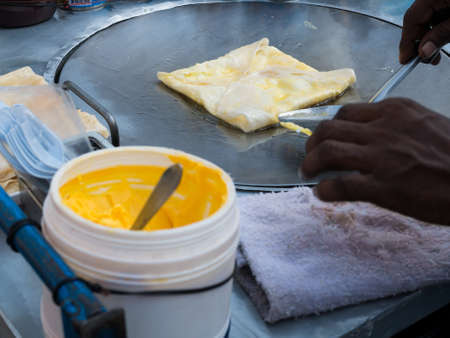 Cooking roti on oily pan