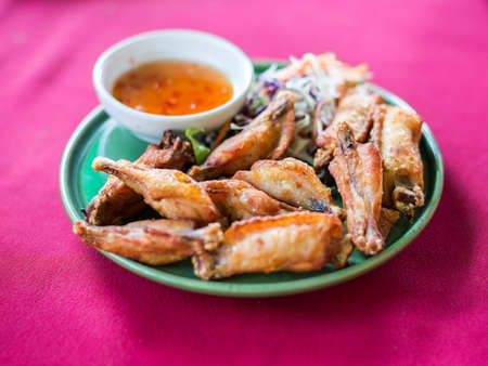Fried chicken with sauce on pink table.の写真素材