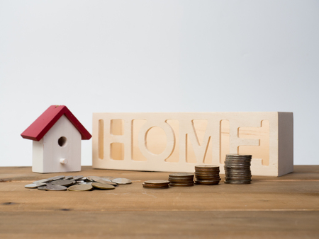 Money coins stack growing with red house on wood background. Business growth investment and financial concept ideas.Real estate investment. House and coins on table.Save money with stack coin.の写真素材