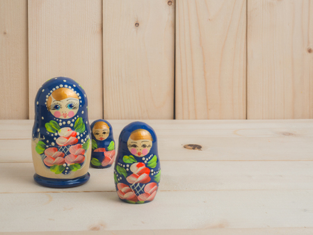 Travel around the world for your colorful life .Enjoy the funny trip journey .Top view for copy space some idea your create destination .object  cute  ,  Set of matrioshka dolls on pine wood  background.の写真素材