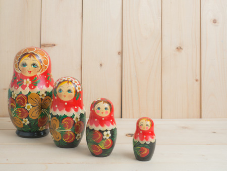 Travel around the world for your colorful life .Enjoy the funny trip journey .Top view for copy space some idea your create destination .object  cute  ,  Set of matrioshka dolls on pine wood  background.の写真素材
