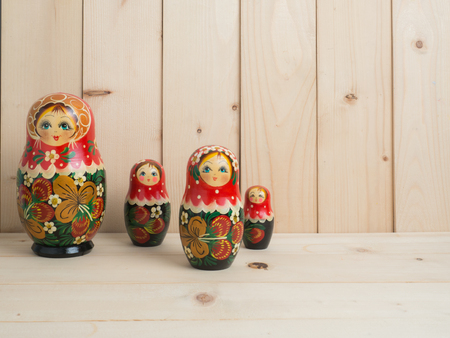 Travel around the world for your colorful life .Enjoy the funny trip journey .Top view for copy space some idea your create destination .object  cute  ,  Set of matrioshka dolls on pine wood  background.の写真素材