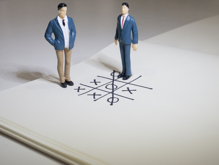 Business and direction concept. Businessman small figure standing on paper and center of circle with more arrows point to many direction.Business concept idea.の写真素材