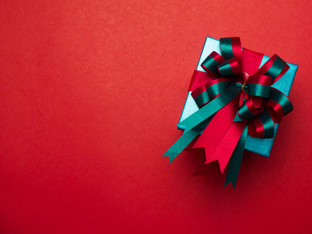 Valentine festival , New year Gold gift box with red ribbon. Red background for create idea copy space.の写真素材