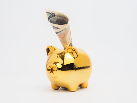 Piggy bank gold color and stack of money safe.Piggy Bank Money Saving Finance Conceptの写真素材
