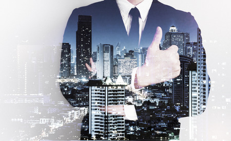 Double exposure of success business man city background.の写真素材