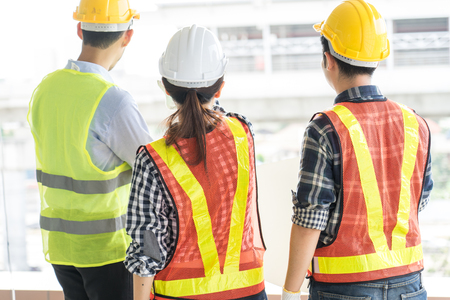engineers visit the construction site.Examining blueprint with construction manager.の写真素材
