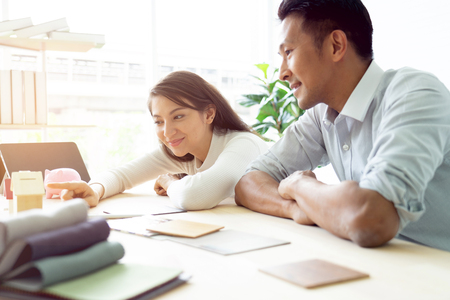 Happy couple plan buying house.Concept for Couple saving money for buy home and real estate. Select material for decorate furniture.の写真素材