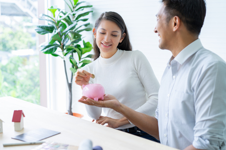 Happy couple plan buying house.Concept for Couple saving money for buy home and real estate. Select material for decorate furniture.の写真素材