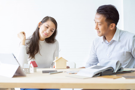 Happy couple plan buying house.Concept for Couple saving money for buy home and real estate. Select material for decorate furniture.の写真素材