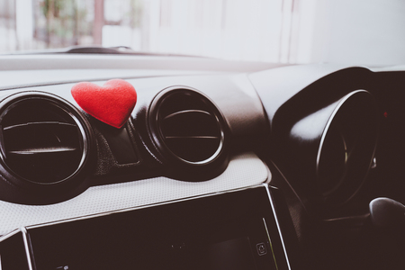 Steering wheel with heart red object.Love car concept idea.interior console car.の写真素材