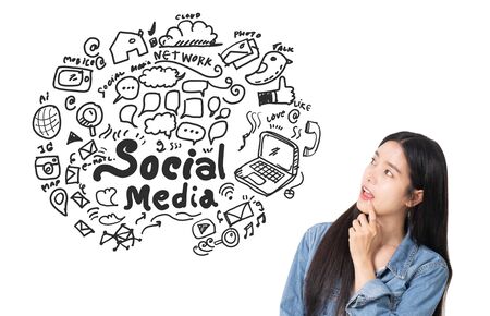 Asian young woman looking up of Hand drawn illustration of social media sign and symbol doodles...