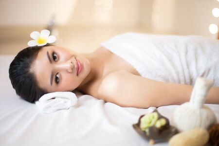Asian Beautiful, young and healthy woman in spa salon. Massage treatment spa room  . Traditional medicine and healing concept.の写真素材