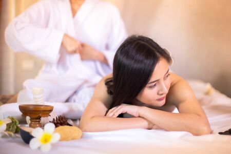 Asian Beautiful, young and healthy woman in spa salon. Massage treatment spa room  . Traditional medicine and healing concept.の写真素材