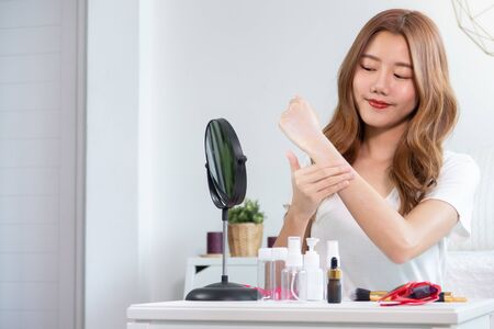 Portrait of young asian woman review giveaway gift product fan following channel, recording video make up lipstic cosmetic at home. Beauty blogger present beauty cosmeticsの写真素材