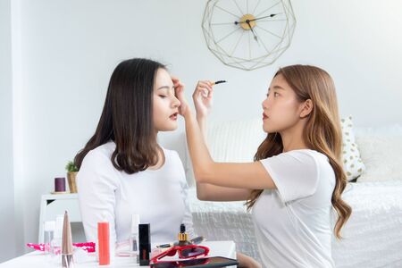 Portrait of young asian woman review giveaway gift product fan following channel, recording video...