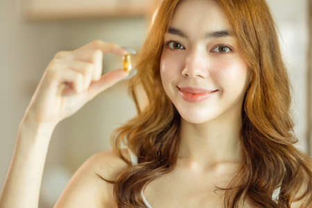 Beauty asian  Pregnant woman  holding vitamin pill isolated at home.healthcare and medical concept.の写真素材