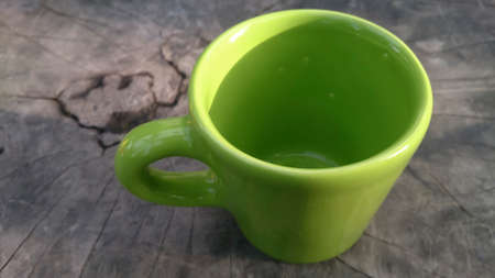 A tea cup colourful on  the dark wood.の写真素材