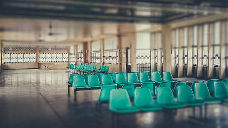Interior an abandoned chairs on hospital with light streaming.の写真素材