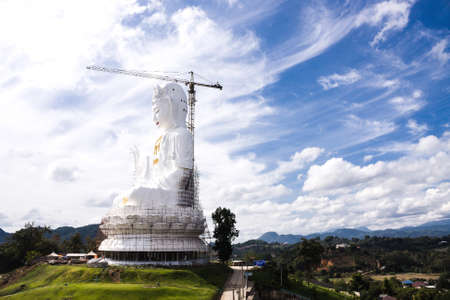 Chiang Rai Province Thailand, January 01, 2016: White Guanyin Statue The Goddess Of Compassion (In Chinese Buddhism) At Wat Huai Pla Kang With Blue Sky Background.の写真素材